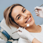 a dental implant patient smiling during an exam.