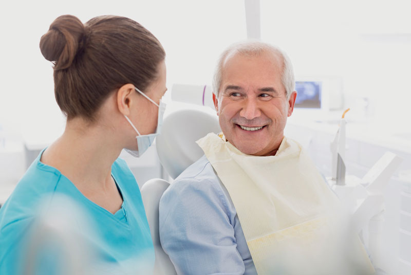 an image of a dental patient smiling with all-on-4 dental im plants.