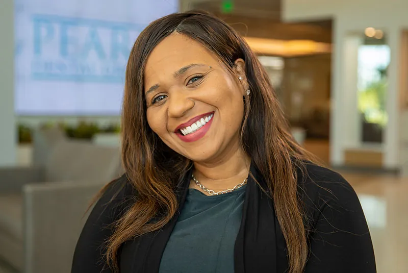 Smiling patient showing the results of a custom smile makeover by Dr. Andre Bruni at Pearl Dental Group in Baton Rouge with beautifully restored, natural-looking teeth.